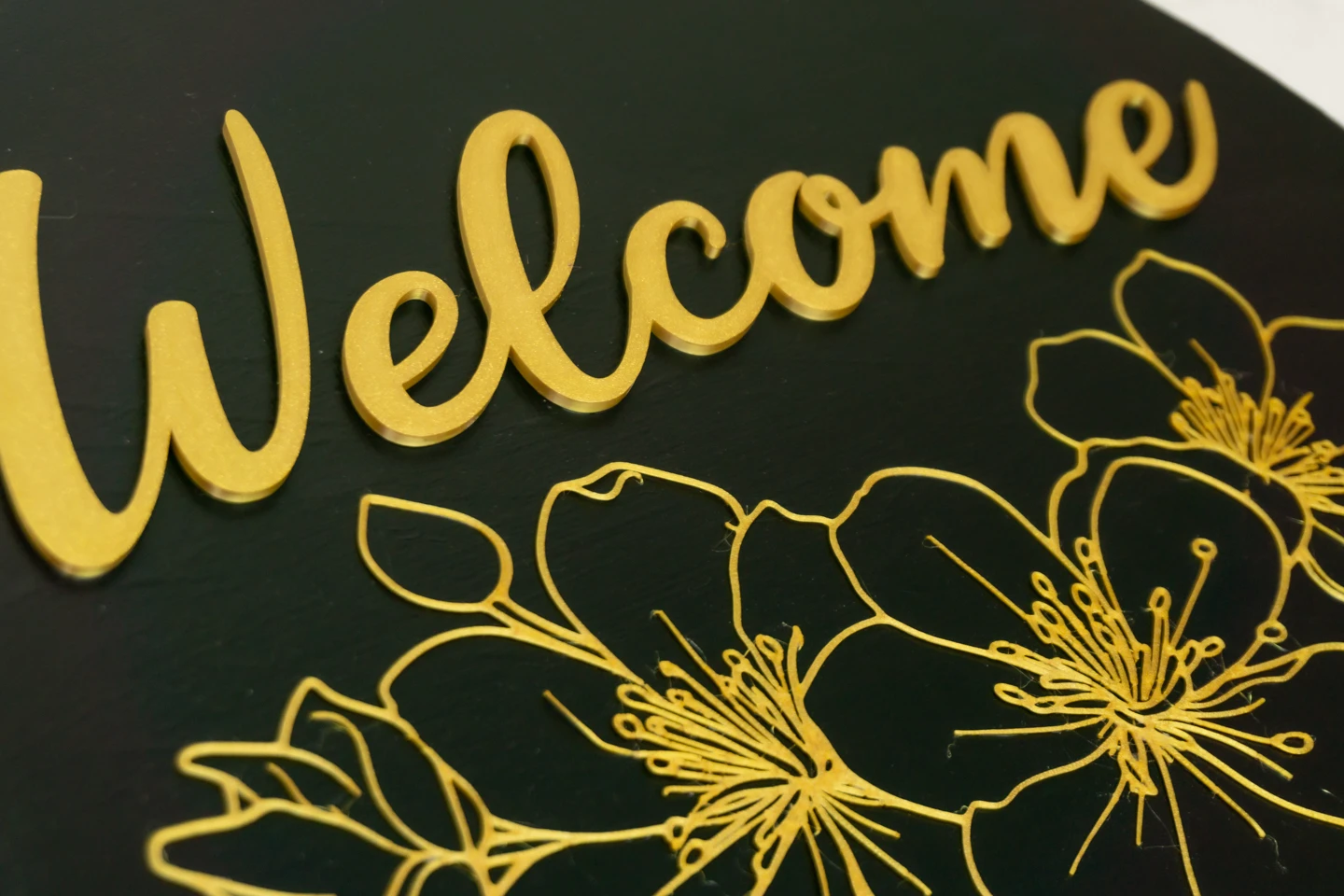 close up of the welcome sign showing 3d lettering on a black background